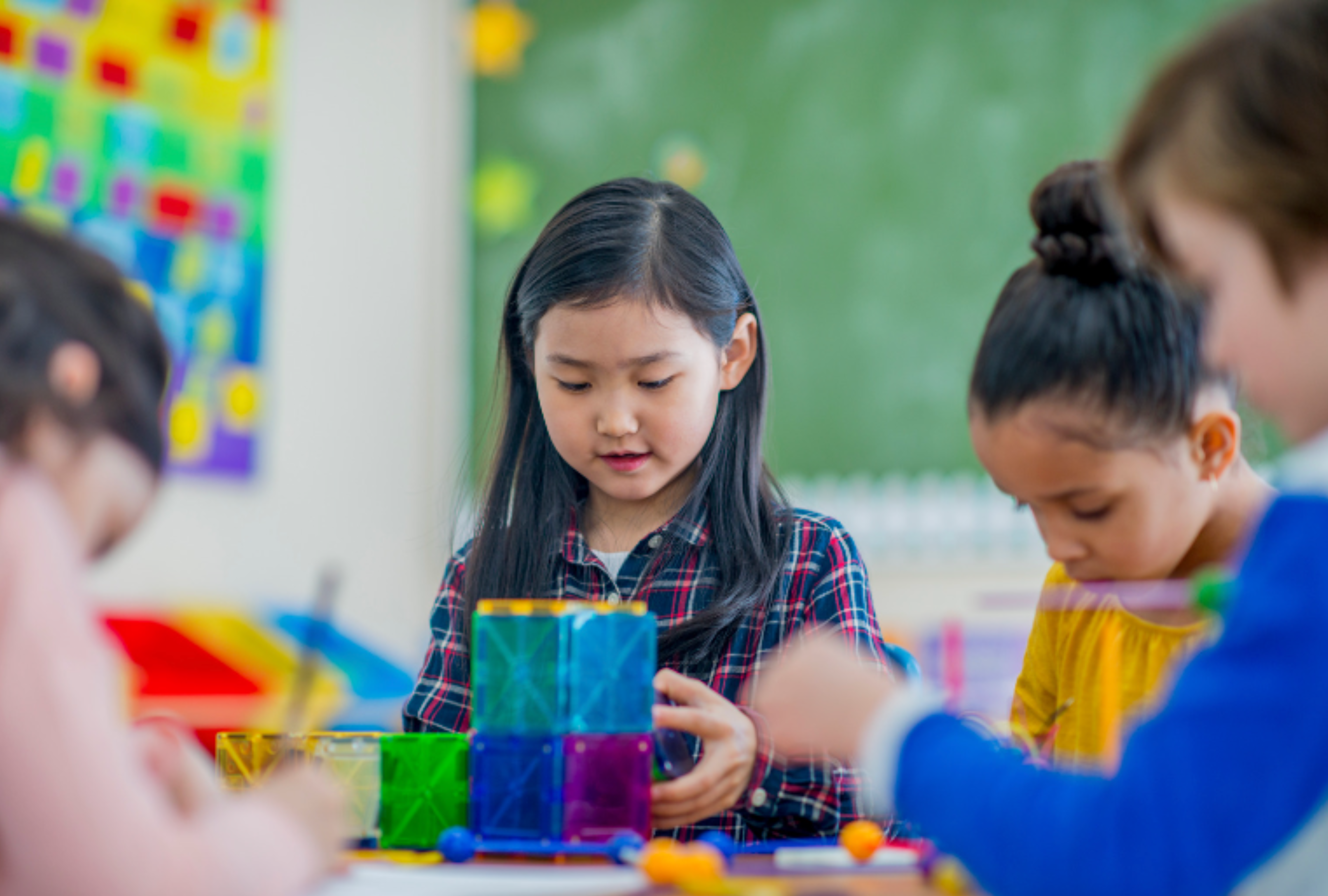 Children build towers with magnatiles