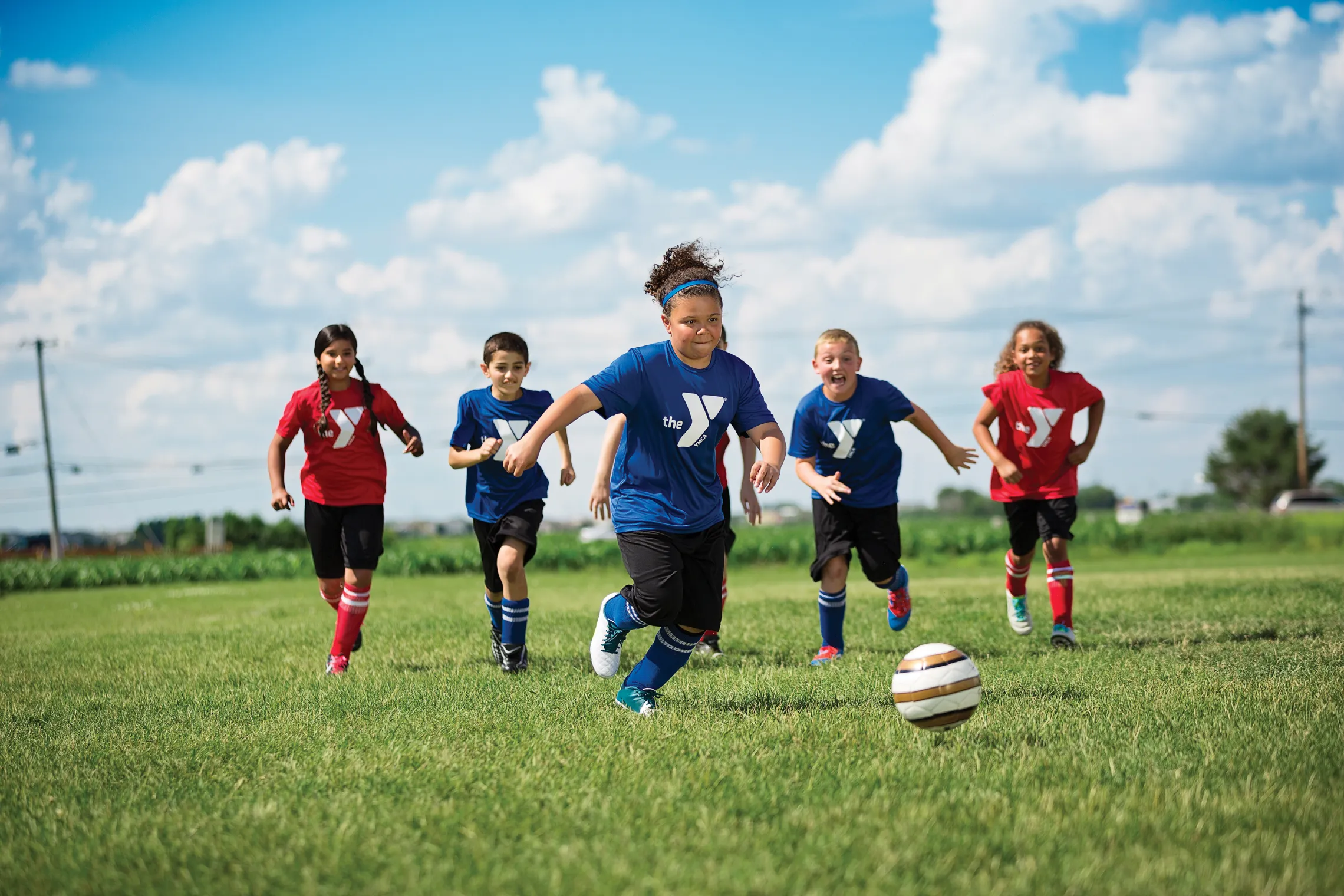 group of kids outside playing soccer