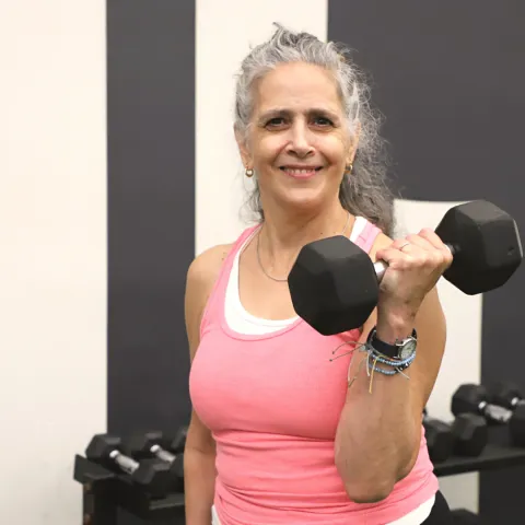 female personal training holding dumbbell