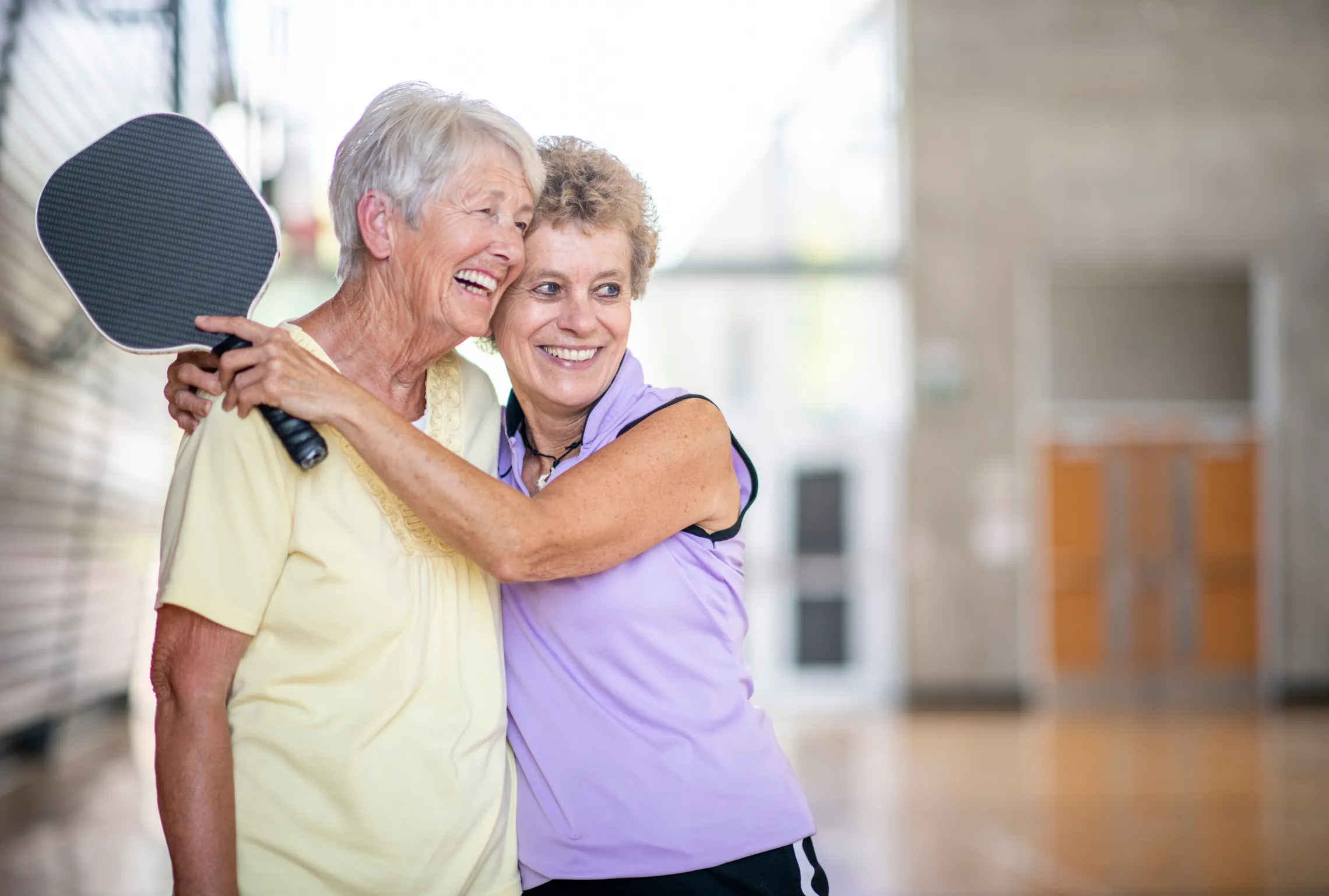 female friends playing pickleball