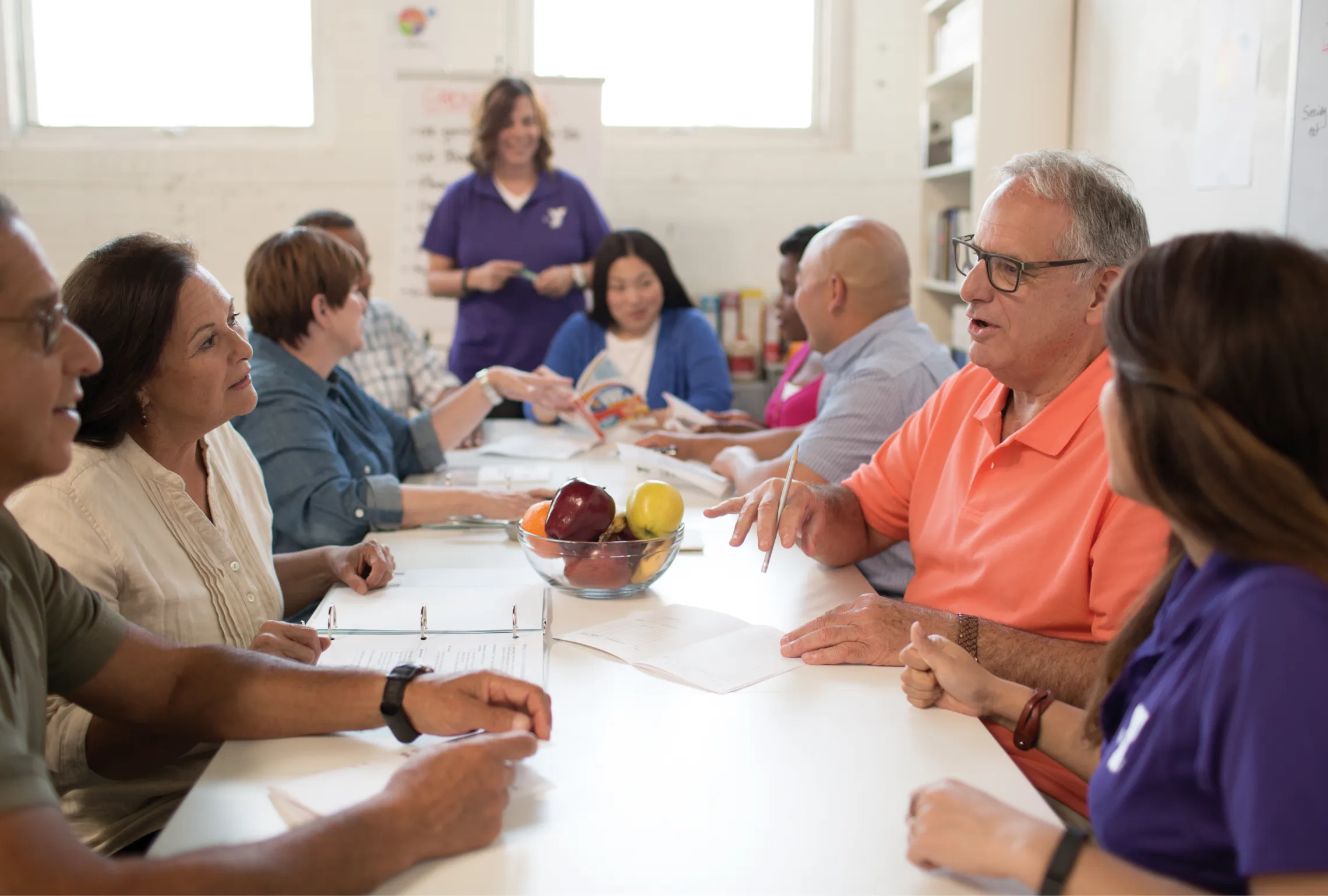 group of adults sitting at a table talking