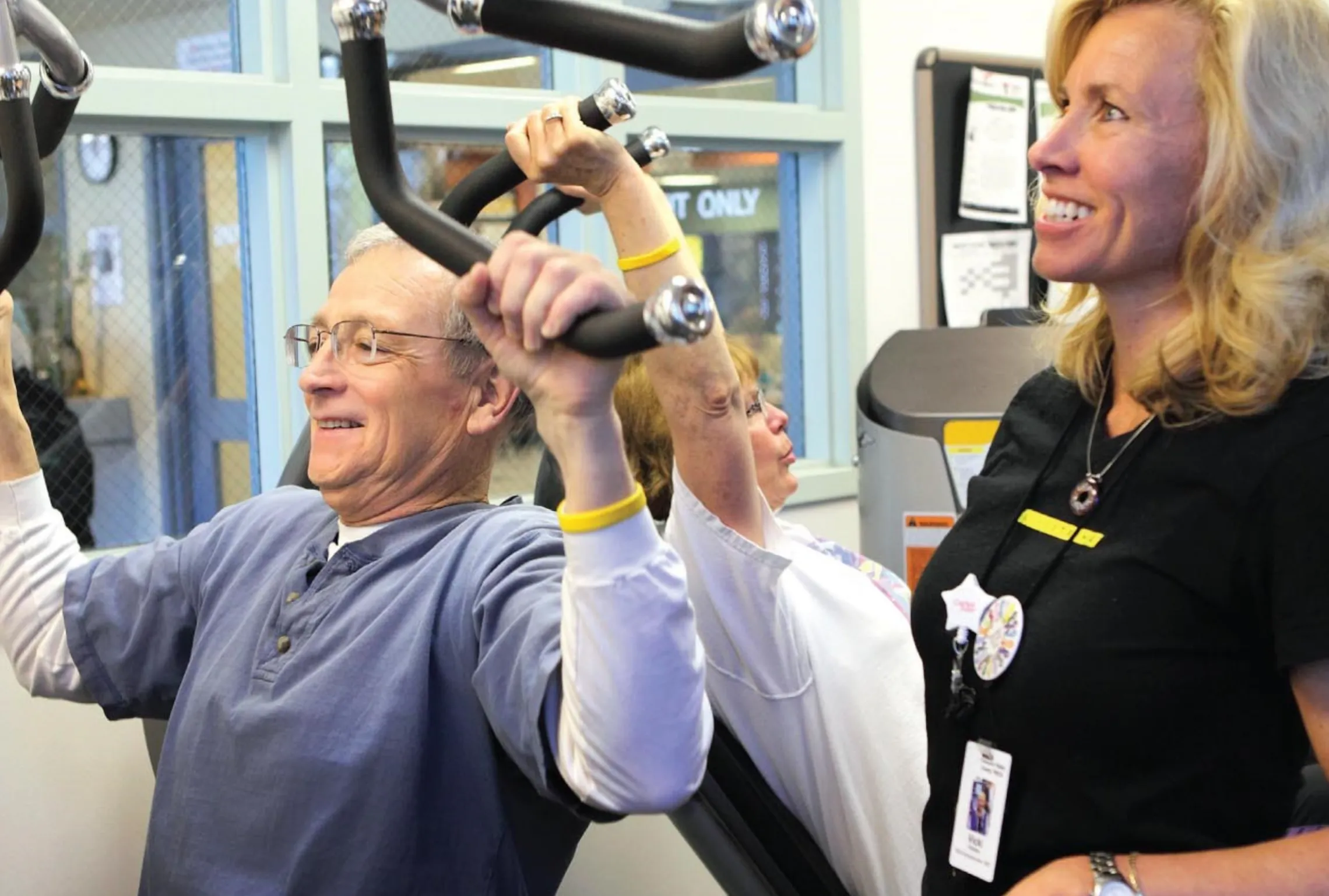 older adult male exercising with trainer