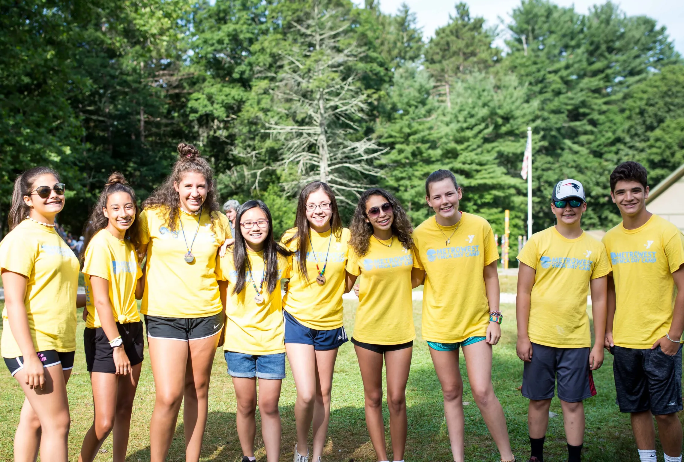 group photo of teens outside smiling