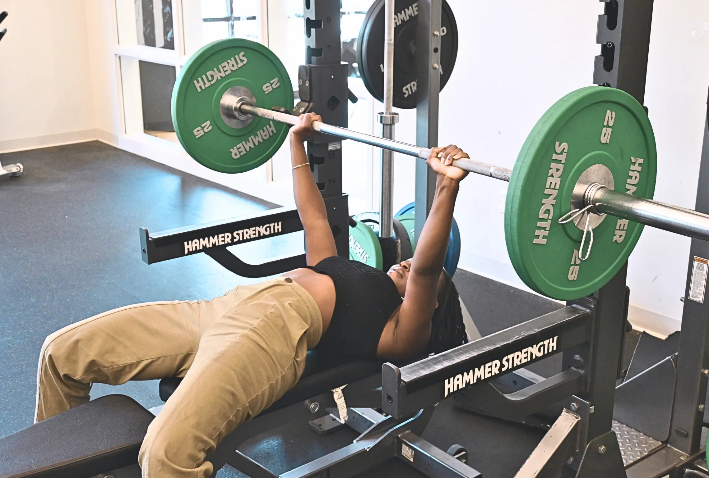 A woman lifts weights as part of the Strengths and weights Group exercise class