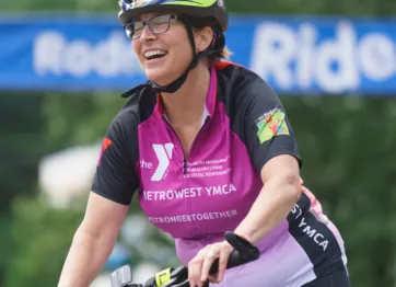 volunteer fundraiser rides her bike in the Rodman Ride for Kids to raise funds for local  Y youth programs