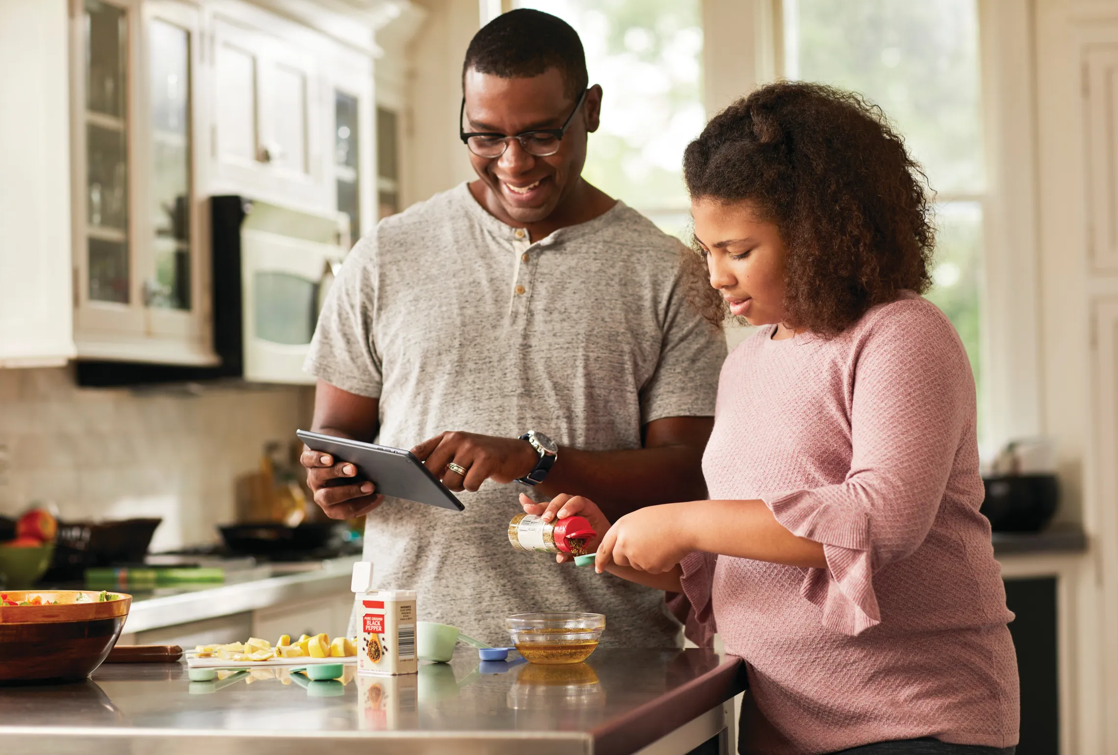 father and daughter cooking together