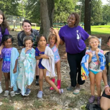 group photo of kids and camp counselors outside